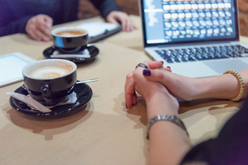 Full concentration at work. Group of young business people working and communicating while sitting at the modern  coffee shop.