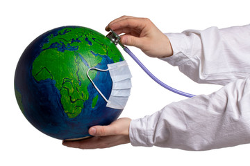 Concept of global problems of planet earth. Diseases, viruses, infections, epidemics. Air pollution of the environment. The doctor's hands with a phonendoscope treat the planet earth in a medical mask