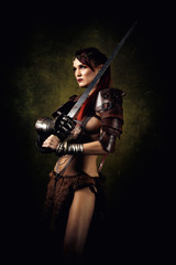 Portrait of a sexy warrior with a sword on her shoulder