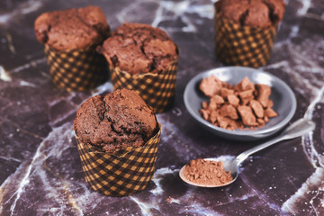 Homemade chocolate muffins on dark marbel background