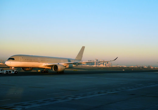 Plane with an airfield tractor at the airport