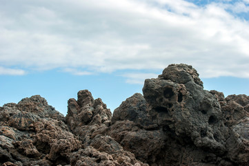Amazing volcanic rocks against the blue sky. Can be used as a background.
