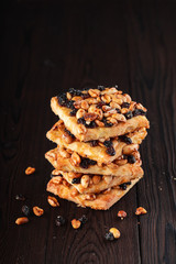 Stack of healthy whole grain cookies with raisins and peanut on wooden table