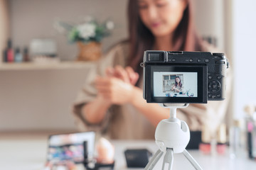 Makeup Beauty fashion blogger recording video presenting makeup cosmetics at home influencer on social media concept.
