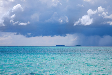 Turquoise blue sea water shore and cloudy sky