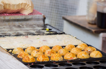 Process to Cooking Takoyaki ball dumplings on hot pan.Takoyaki is a most famous Japanese snack food in Japan.