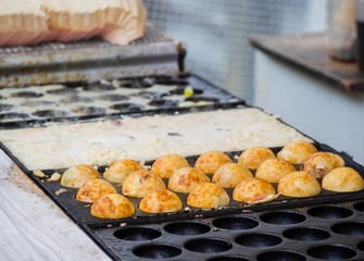 Process to Cooking Takoyaki ball dumplings on hot pan.Takoyaki is a most famous Japanese snack food in Japan.