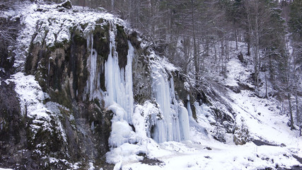 Fototapeta na wymiar Frosted Waterfall Brook in Winter, Creek Icicle on Mountain Cliffs, Frozen Snow
