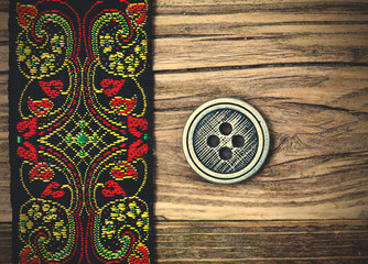 old band with embroidered ornaments and vintage button