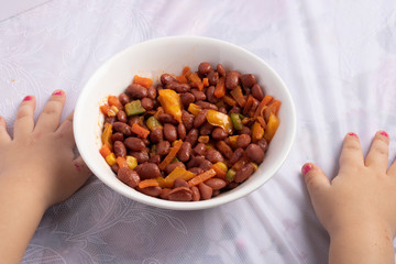 Red beans with white plate near kids hands