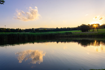 Fototapeta premium Sunset over a small dam in the Johannesburg Botanical Gardens