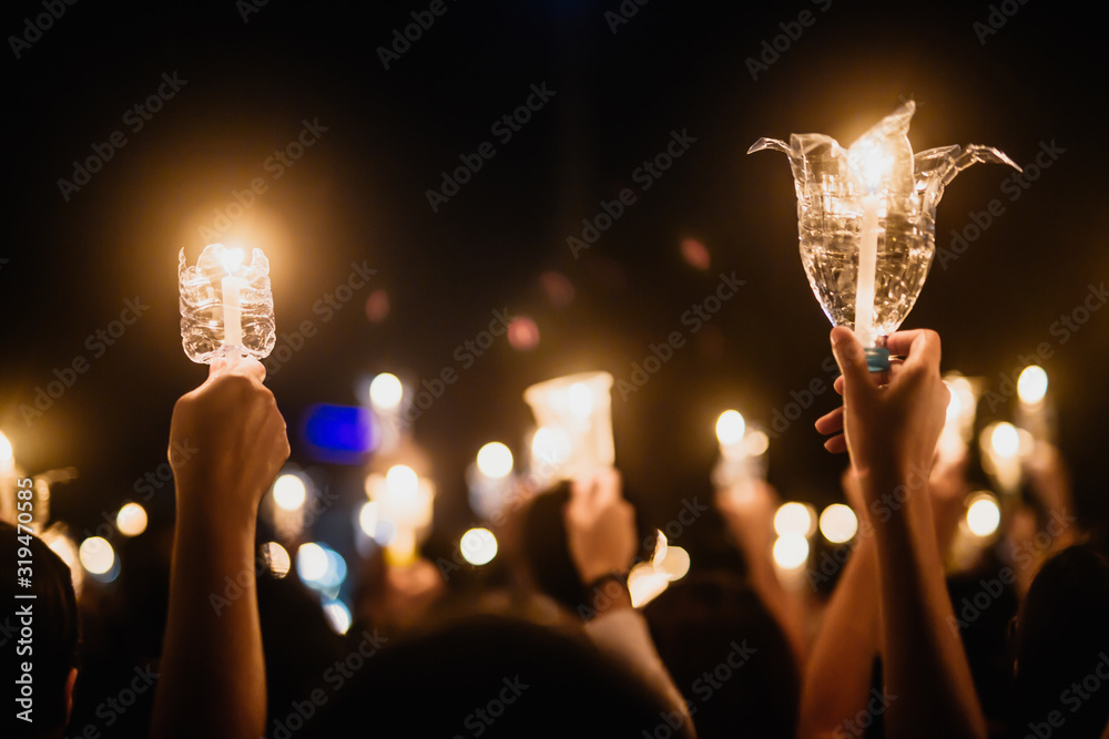 Wall mural people hand holding candle for pray