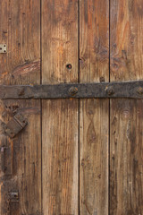 Old fence boards with a rusty lock. Rustic background with space for text
