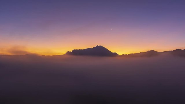 Timelapse of Beautiful Sunrise Mountain Kinabalu with moving cloud in Sabah Borneo, Malaysia.