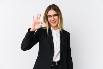 Young business caucasian woman cheerful and confident showing ok gesture.