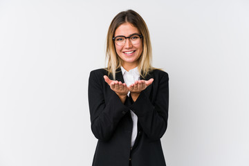 Young business caucasian woman holding something with palms, offering to camera.
