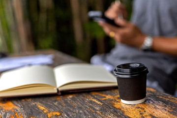 Fototapeta na wymiar Little cup of coffee near the book on the table.