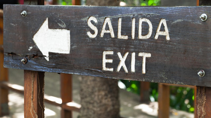 Exit in Spanish and English, black information board