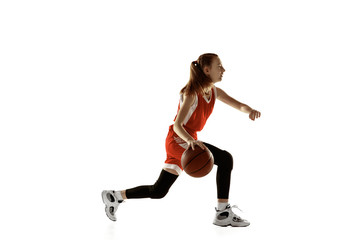 Fototapeta na wymiar Young caucasian female basketball player in action, motion in run isolated on white background. Redhair sportive girl. Concept of sport, movement, energy and dynamic, healthy lifestyle. Training.