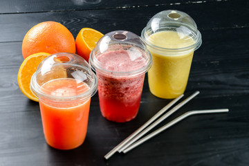 set three smoothies and fresh juices in a take-out glass