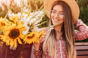 Happy woman admiring flowers on summer day