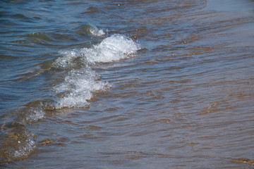 Waves and black sand of volcanic origin. Baia Domizia Coast, Province of Caserta, Italy