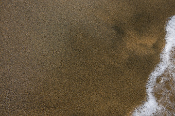 Waves and black sand of volcanic origin. Baia Domizia Coast, Province of Caserta, Italy