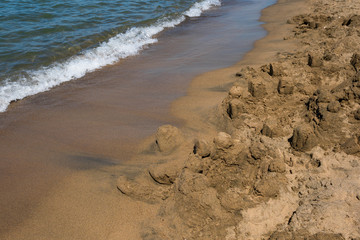Waves and black sand of volcanic origin. Baia Domizia Coast, Province of Caserta, Italy