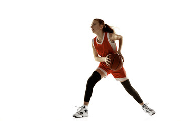 Fototapeta na wymiar Young caucasian female basketball player in action, motion in run isolated on white background. Redhair sportive girl. Concept of sport, movement, energy and dynamic, healthy lifestyle. Training.