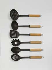 Kitchen ladles displayed in a vertical row. Isolated on white background