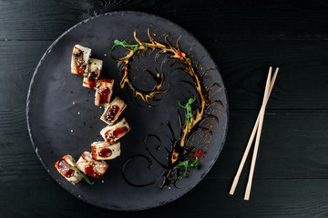 beautiful japanese sushi decorated on a black plate