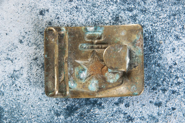 Old brass belt buckle with a star