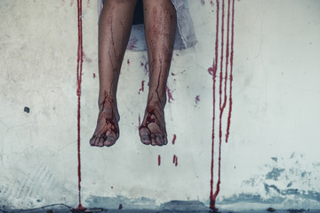 horror scence leg of women sitting and blood on the wall at abandoned house. Halloween concept