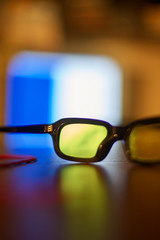 glasses for vision on a table on a colorful background