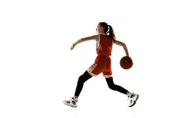 Fototapeta na wymiar Young caucasian female basketball player in action, motion in run isolated on white background. Redhair sportive girl. Concept of sport, movement, energy and dynamic, healthy lifestyle. Training.