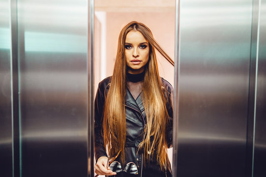 Elevator Door From Inside One Female Young Woman Fashion Model Caucasian With Black Coat Approaching Between The Opening Or Closing Door Metal Metallic