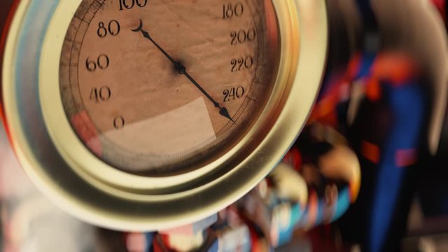 Vintage pressure gauge closeup, indicator arrow at maximum, risk of accident. Pressure gauge about to explode