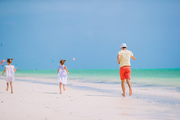 Father and little kids on the beach