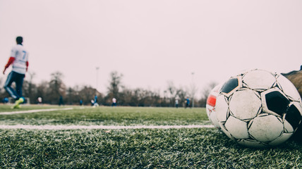 Men play soccer, attacker runs with the ball, defocused blur sport background image