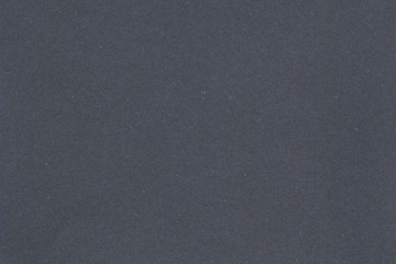 Black vintage rough sheet of carton. Recycled environmentally friendly cardboard paper texture. Simple gray minimalist papercraft background.