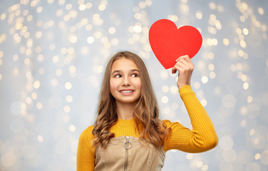 valentine's day, love and people concept - smiling young teenage girl with red heart over festive...