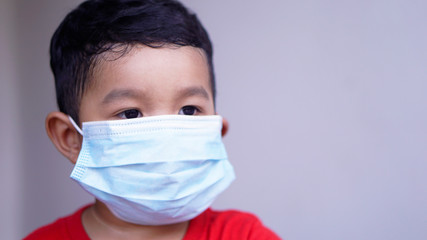 Pm2.5 and Coronavirus Air pollution concept. Little Asian or Chinese boy wearing mask for protect pm2.5 bad air. Wuhan coronavirus and epidemic virus from china.                                 