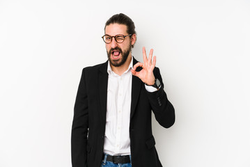 Young caucasian business man isolated on a white background winks an eye and holds an okay gesture...