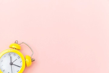 Ringing twin bell vintage classic alarm clock Isolated on pink colourful trendy pastel background....