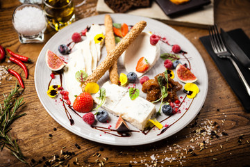 Cheese platter for two served on a plate in restaurant