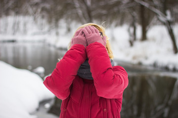 A young girl in a winter park on a walk.