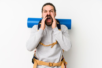 Young backpacker man isolated on a white background shouting excited to front.