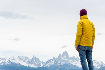 Fototapeta na wymiar Alone hiker with yellow jacket admiring views over Mount Fitz Ro