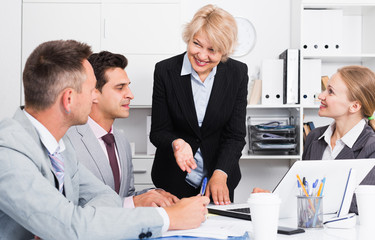 Fototapeta premium Business woman explaining strategy to partners