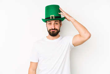 Young caucasian man wearing a saint patricks hat isolated being shocked, she has remembered important meeting.